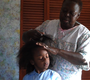 Geleta Turnquest brushes Gracie's hair