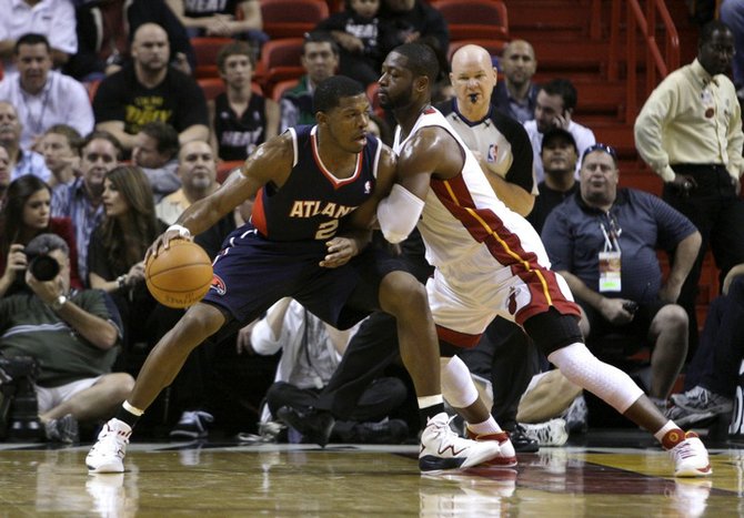 Atlanta Hawks' Joe Johnson (2) tries to get past Miami Heat's Dwyane Wade, right, during the first half of an NBA basketball game, Monday, Jan. 2, 2012, in Miami. (AP Photo/Lynne Sladky)