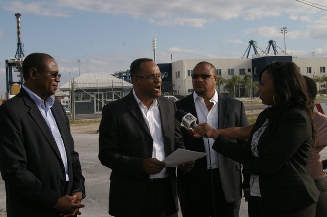 Senator Michael Darville makes a statement to the press on the 72 terminations at the Freeport Container Port, Grand Bahama Airport Company, and Freeport Harbour Company alongside, (left) Julian Russell, PLP candidate for Central Grand Bahama, and Gregory Moss, PLP candidate for Marco City.