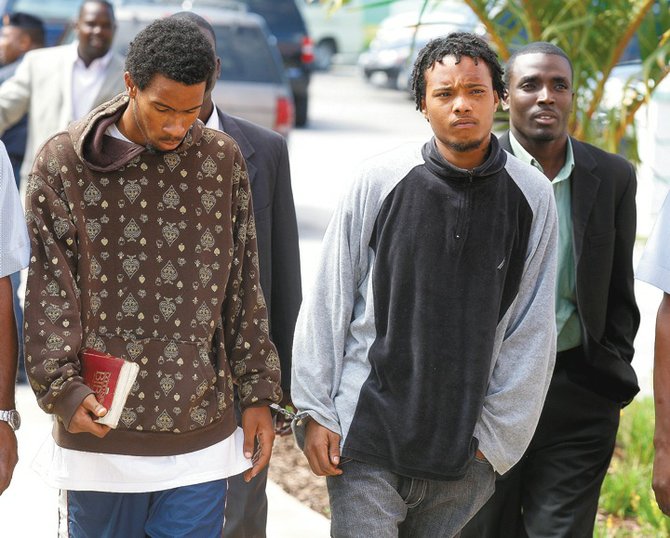 Sebastian Cartwright, left, holding a Bible, and Ravon Dwight Major outside of court.