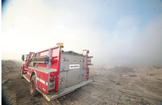 Firefighters in the thick of the smoke where they continued to damp down the fire.