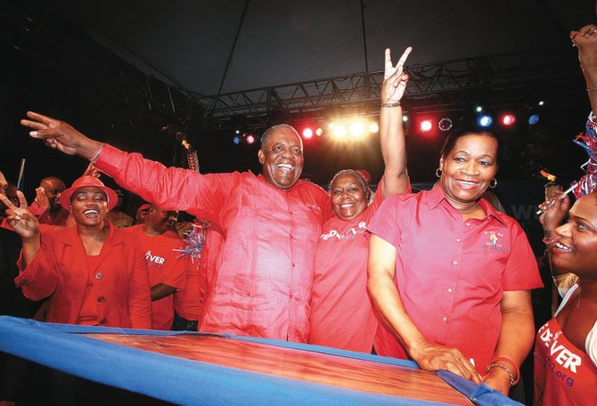 Prime Minister Hubert Ingraham embraces former speaker Janet Bostwick at Thursday night's FNM rally.