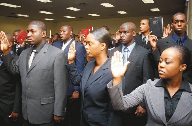 The new police recruits are sworn in.