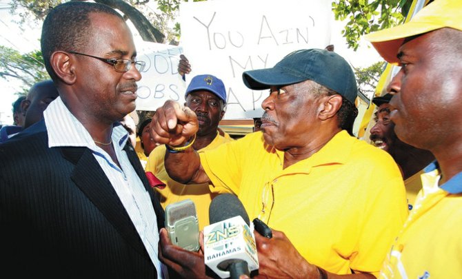 Minister of National Security Tommy Turnquest is confronted by Bain and Grants Town candidate Dr Bernard Nottage.