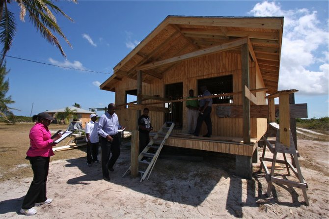 NEMA officials and building inspector Selina Curry of the Ministry of Works inspect a house. Photo: Kris Ingraham/BIS