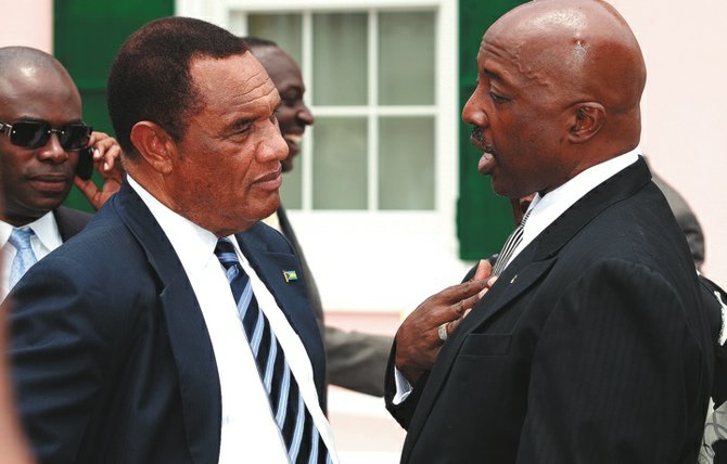 Prime Minister Perry Christie talks to Minister of Labour Shane Gibson outside of the House of Assembly.