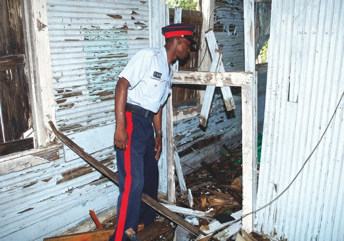 A police officer inspects an abandoned building before it is demolished at the start of the Urban Renewal 2.0 scheme.