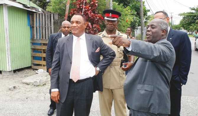 Deputy Prime Minister Philip ‘Brave’ Davis points to the area where he grew up during the Urban Renewal 2.0 launch earlier this week. Prime Minister Perry Christie and Superintendent Stephen Dean are also pictured looking on.