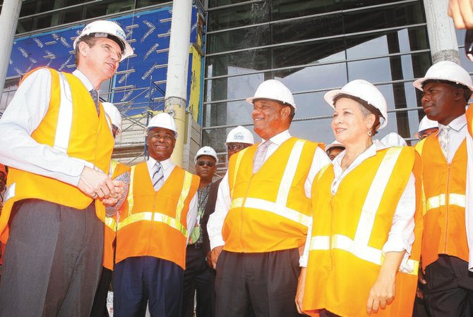 Nassau Airport Development Company President and CEO Stewart Steeves talks to Prime Minister Perry Christie and Minister of Transport and Aviation Glenys Hanna-Martin. Mrs Hanna-Martin announced that a statue of Sir Lynden Pindling will be raised at the airport.