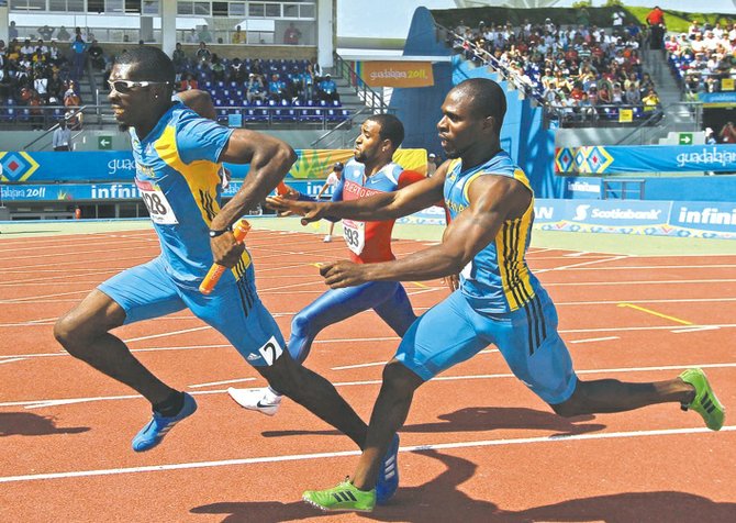 Bahamas' Rodney Green hands the baton off to Wesley Neymour in the men's 4x100 relay semifinals at the Pan Am Games in 2011.