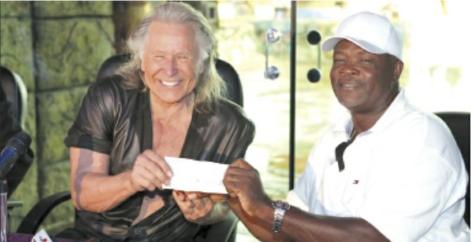 Peter Nygard presents a $10,000 cheque to Stafford Armbrister of the All-Andros Regatta.