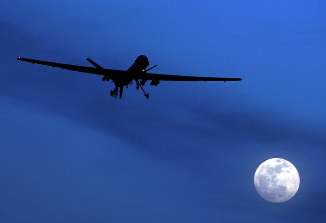FILE - This Jan. 31, 2010 file photo shows an unmanned U.S. Predator drone flies over Kandahar Air Field, southern Afghanistan, on a moon-lit night. After a decade of costly conflict in Iraq and Afghanistan, the American way of war is evolving toward less brawn, more guile. Drone aircraft spy on and attack terrorists with no pilot in harm's way. Small teams of special operations troops quietly train and advise foreign forces. Viruses sent from computers to foreign networks strike silently, with no American fingerprint. (AP Photo/Kirsty Wigglesworth, File)