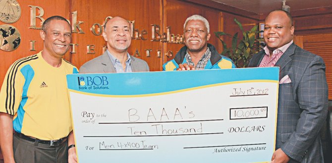 GOING FOR THE GOLD -- Bank of The Bahamas (BOB) kicked off a national campaign today to raise funds for the Bahamas Men’s 4x400 Relay Team with the bank’s donation of $10,000. Over the next two weeks before the opening of the Summer Olympics in London and under the theme Journey to London, BOB will collect funds in branches or by phone to the credit card centre. Pictured, l-r, BAAA Coordinator Shervin Stuart, BOB Deputy Managing Director Vaughn Delaney, BAAA President Mike Sands, and BOB Narketing Manager Michael Basden. (Photo by Roland Rose for DPA).      
