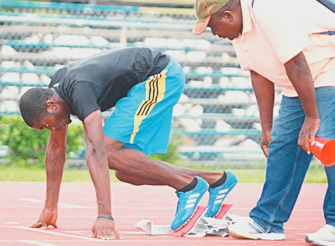 AND HE’S OFF: Wesley Neymour on the starting blocks as he trains with his coach Rupert Gardiner. The 23-year-old’s decision to step down from the 800m to run the 400m paid off big dividends as he’s now on his way to represent the Bahamas at his first Olympic Games in London, England.