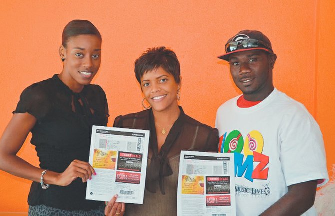 100 Jamz morning show personality, Les Boogie (centre), presents winners, Latasha Rolle (left) and Alfred McBride (right) with their prizes. 
