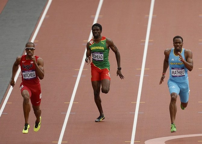 Michael Mathieu and Maurice Mitchell (USA) compete in the men's 200m heats during the London 2012 Olympic Games at Olympic Stadium.  John David Mercer-USA TODAY Sports