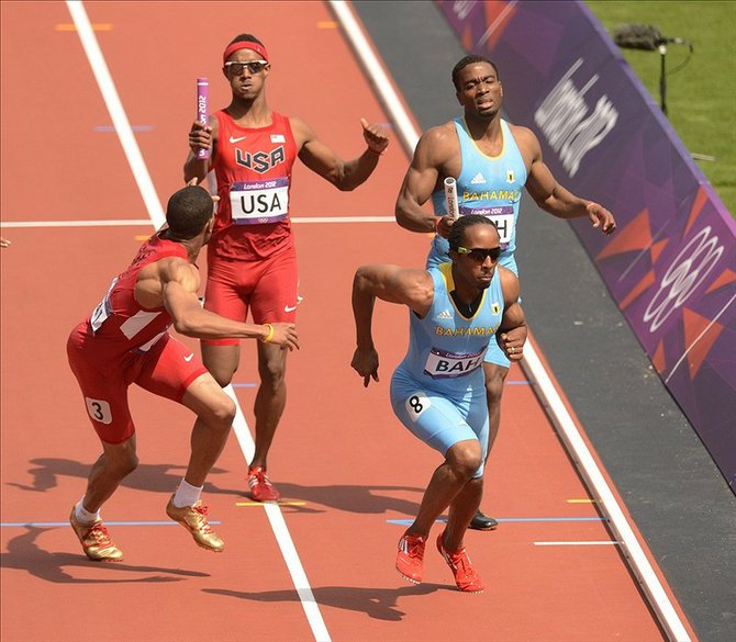 Tony McQuay (USA) and Michael Mathieu (BAH) hand off to Bryshon Nellum (USA) and Chris Brown (BAH) in the men's 4x400m heats during the London 2012 Olympic Games at Olympic Stadium. John David Mercer-USA TODAY Sports