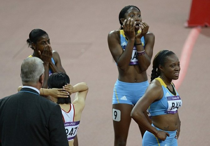 Christie Amertil, Anthonique Strachan and Sheniqua Ferguson react while Chandra Sturrup, not pictured, competes in the women's 4x100m relay heats during the London 2012 Olympic Games at Greenwich Park. Bob Donnan-USA TODAY Sports