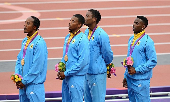 Chris Brown, Demetrius Pinder, Michael Mathieu and Ramon Miller listen to the Bahamas national anthem on the podium after receiving their gold medal in the men's 4x400m relay during the London 2012 Olympic Games at Olympic Stadium. James Lang-USA TODAY Sport.