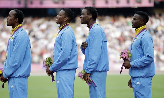 The Bahamas' men's 4x400-metre relay team of Chris Brown, Demetrius Pinder, Michael Mathieu and Ramon Miller pose with their gold medals during the 2012 Olympic Games in London. (AP)