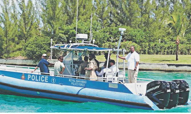 Officials tour Grand Bahama's waterways aboard the marine interceptor speedboat.