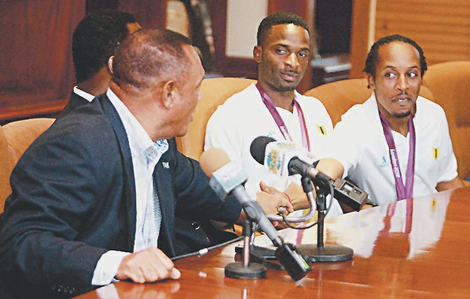 EXAMPLE SETTERS: Chris “Fireman” Brown (far right) and Ramon “Fearless” Miller listen to Prime Minister Perry Christie.    Photos by Felipé Major/Tribune staff


