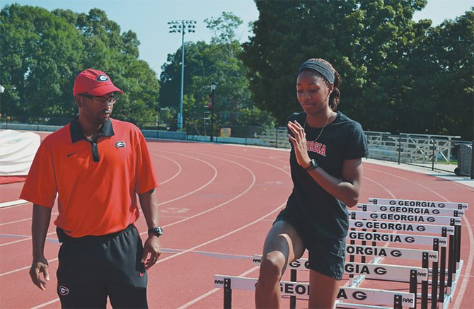 Coach George Cleare and Shaunae Miller go through a training session at the University of Georgia.