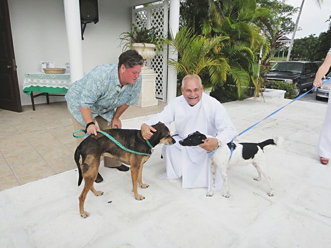 Archdeacon Keith Cartwright after the blessing of the Animals at St Christopher’s church, with Amanda Myers and her dog Roxy and George (a BHS adoption dog).

