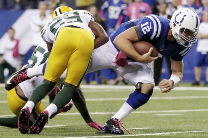 Indianapolis Colts quarterback Andrew Luck (12) dives for a first down as he is tackled by Green Bay Packers cornerback Casey Hayward during the second half of an NFL football game in Indianapolis, Sunday. (AP)