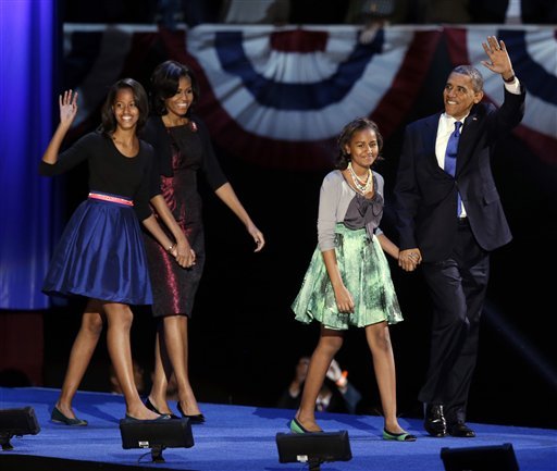 President Barack Obama waves as he walks on stage with first lady Michelle Obama and daughters Malia and Sasha at his election night party. (AP)