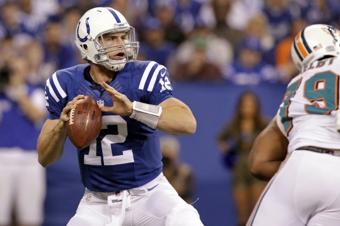 Indianapolis Colts quarterback Andrew Luck (12) throws against the Miami Dolphins during the first half of an NFL football game in Indianapolis, Sunday, Nov. 4, 2012. Luck threw for 433 yards and two touchdown passes, breaking Carolina Panthers quarterback Cam Newton's single-game passing record (422 yards) for a rookie as he led the Colts to a 23-20 win. (AP Photo/AJ Mast)
