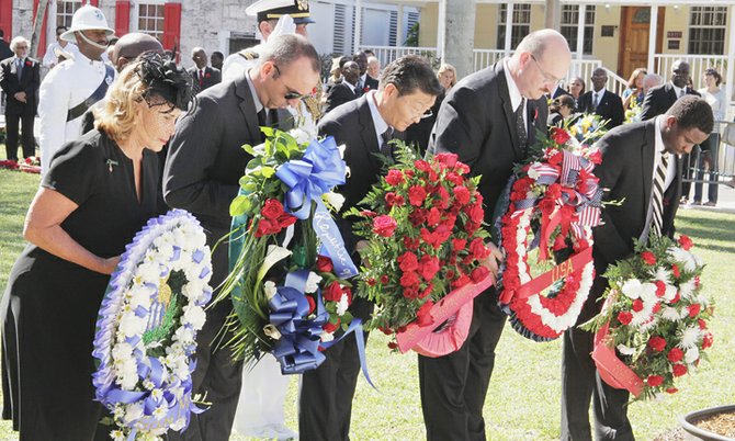 Representative members of the Diplomatic Corps lay wreaths at the Cenotaph in the Garden of Remembrance yesterday as part of the Bahamas' Remembrance Day service. PHOTO: Derek Smith