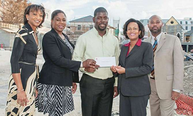 CIBC FirstCaribbean’s managing director, Marie Rodland-Allen (second from right), presents the Downtown Nassau Partnership’s project manager, Gevon Moss (centre), with a donation valued at $25,000 to help with financing the redevelopment of Nassau’s city centre, including the historic Pompey Museum site. Also shown are DNP’s director, Inga Bowleg (left); CIBC FirstCaribbean’s marketing manager, Andrea Myers-Tanguay (second from left); and DNP’s director, Jermaine Wright, is pictured at right.
