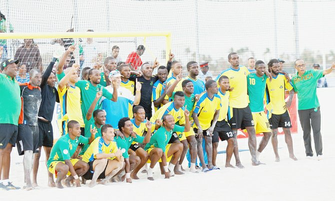 ONE LOVE: Bahamian and Jamaican players pose after a friendly to officially launch the opening of the beach soccer facility located just west for the Sidney Poitier Bridge, Malcolm Park North, on Saturday. (Photo: Tim Clarke/Tribune Staff).