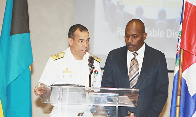 Rear Admiral Felix Alburerque-Compress of the Dominican Republic Navy (left) addresses the opening sessionof the Royal Bahamas Defence Force/Dominican Republic Navy round table discussion on Tuesday at Police Headquarters. Sub-Lieutenant Glen McPhee of the National Intelligence Agency (Bahamas) served as interpreter.