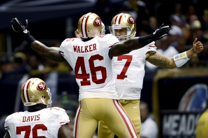 San Francisco 49ers quarterback Colin Kaepernick (7) celebrates his rushing touchdown with tight end Delanie Walker (46) in the first half of an NFL football game against the New Orleans Saints in New Orleans, Sunday. (AP)
