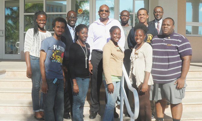 Dr HUBERT Minnis and members of COBUS in front of the Harry Moore Library. From left, front row: Amard Rolle, Marquel Wallace, Lakeisha Rolle, Jan Turnquest, and Alphonso Major. Back row: Lona Bethel, Darron Cash, Dr Minnis, Franklyn Donaldson, Ernesto G Williams, John Bostwick. 

