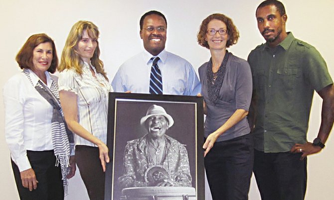From left, Diane Phillips; project manager, Lisa Wells; Minister of Youth Sports and Culture Dr. Daniel Johnson (holding framed photo); NAGB executive director Amanda Coulson; and NAGB curator and Popopstudios founder JOhn Cox.