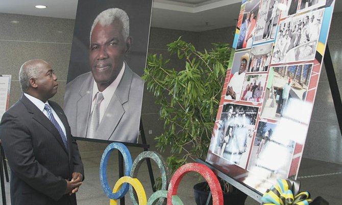 Deputy Prime Minister and Minster of Works Brave Davis looks at the display of Thomas A. Robinson at the Thomas A. Robinson stadium yesterday morning.
