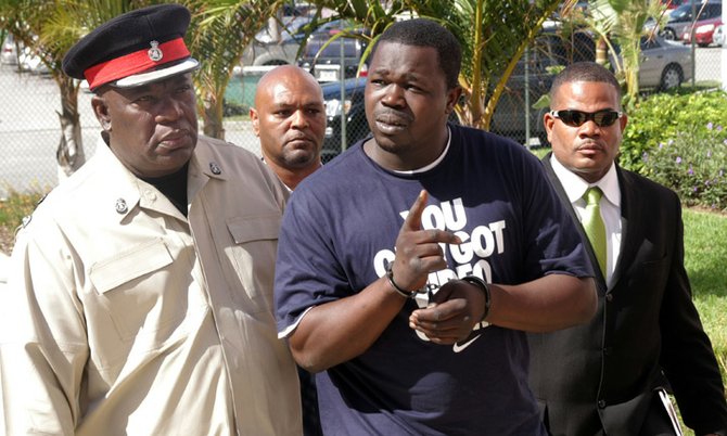 Keno Johnson, centre, escorted to Magistrates Court off Nassau Street yesterday. (Photo: Kyle Smith/ Tribune Staff)