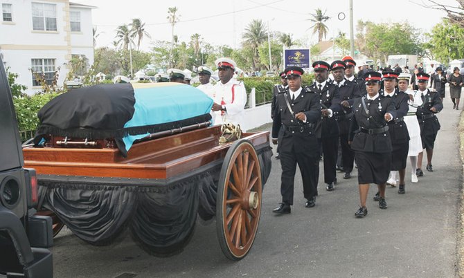 Royal Bahamas Defence Force and Police Force officers march behind Thomas A. Robinson’s casket into the Eastern Cemetery yesterday. (Photo: Kyle Smith/Tribune Staff)
