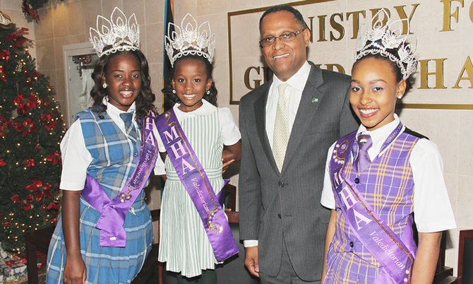 Minister for Grand Bahama Dr Michael Darville congratulates the winners of the Miss Abrave Pageant. The trio is pictured with the minister in the foyer of the Ministry of Grand Bahama. Pictured from left are Rebecca Mader, Miss Ulti; Younique Farquharson, Little Miss High Abrave; Minister Darville and Nichana Miller, Medi Miss High Abrave. Photo: Vandyke Hepburn/BIS
