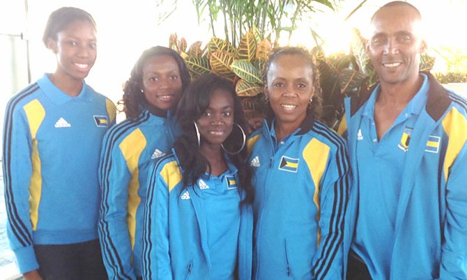 Bahamas NACAC team of Holly Rolle, Veronica Bonimy, Jennaya Hield, coach Sherry Francis and manager Stephen Murray pose above at the Lynden Pindling International Airport before their departure for Jamaica yesterday.