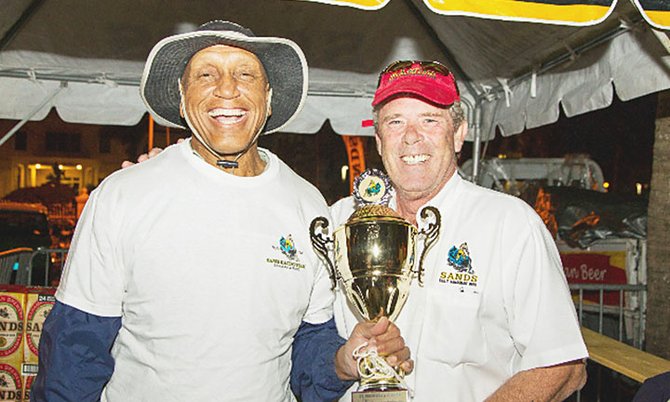Sheldon Gibson receives his Man in Boat Race championship trophy from Bahamian Brewery's owner James 'Jimmy' Sands. Photo courtesy of Tim Aylen.