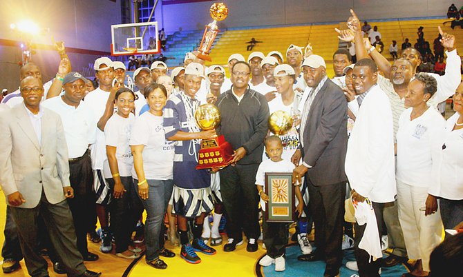 champions: Minister of Sports Dr Daniel Johnson (holding trophy) can be seen with the CC Sweeting Cobras after they defeated the Eight Mile Rock BlueJays (BLUE) 63-53 to claim their second consecutive Hugh Campbell Basketball Classic title at the Kendal Isaacs Gym last night.                                                  Photos by Tim Clarke/Tribune Staff 
                                                                                                                                                                                                                                           
