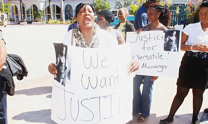 PROTESTERS took to the streets yesterday in Nassau over recent deaths in police custody, such as this woman who took part in the protest outside Parliament, and were joined by people asking for more answers over the recent shooting of Job Munnings. 
Photo: Tim Clarke/Tribune Staff
