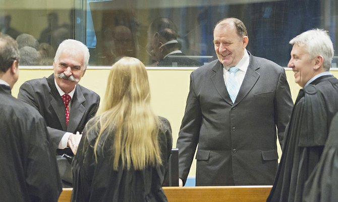 Former Bosnian Serb minister of internal affairs and national police chief Mico Stanisic, second right, and former Bosnian Serb senior security official and police chief Stojan Zupljanin, second left,  arrive in the courtroom prior to their judgment at the Yugoslav war crimes tribunal in The Hague, Netherlands, Wednesday March 27, 2013. UN judges deliver verdicts in the trial of two former Bosnian Serb police chiefs, both charged with crimes including persecution, extermination, murder, torture and deportation for their alleged roles in a criminal conspiracy led by Bosnian Serb President Radovan Karadzic and his military chief Gen. Ratko Mladic to force Muslims and Croats out of what they considered to be Serb territory in Bosnia. (AP Photo/Michael Kooren, pool)