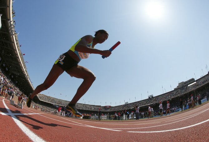 In this image taken with a fisheye lens, Christine Amertil, of the Bahamas, runs the first leg in the woman's 4x400 meter relay at the Penn Relays at Franklin Field in Philadelphia, Saturday. (AP)