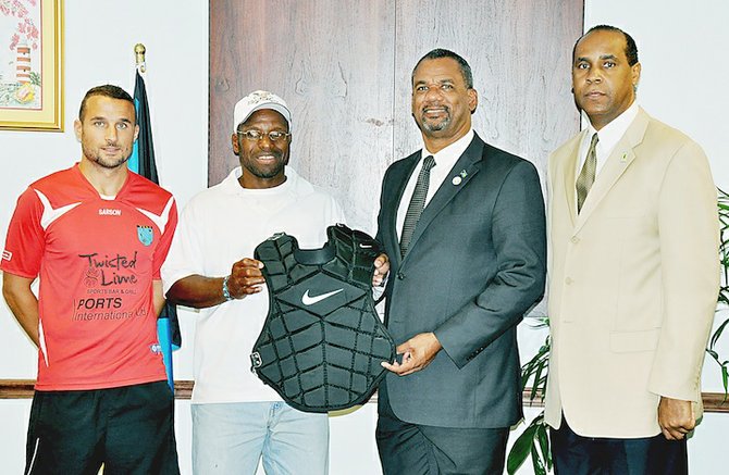Youth Empowerment through Soccer International (YESI) and the Mario Ford Inner-City Baseball League were two youth groups presented with sporting equipment and apparel that Sports Locker donated to the Ministry of Education, Science and Technology. Shown (l-r) are YESI founder Happy Hall, Mario Ford, Jerome Fitzgerald, minister of education science and technology and Evon Wisdom, sportsadministrator.