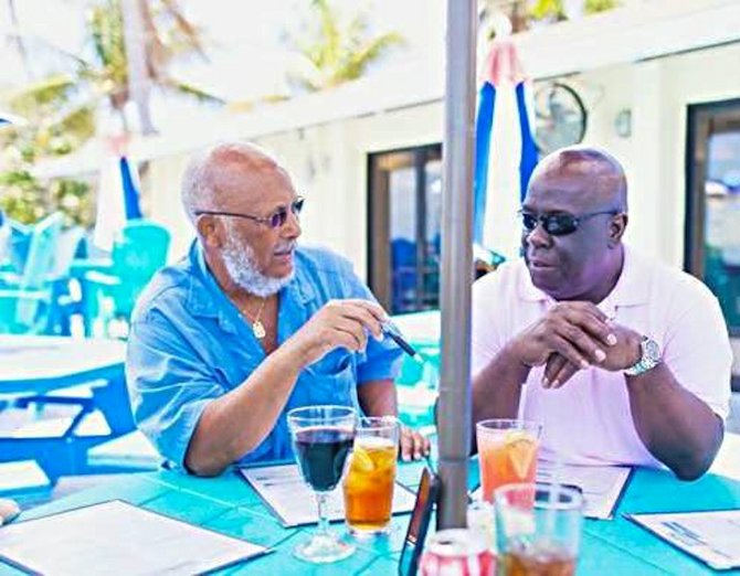 Activist and Save the Bays director Joseph Darville (left) talks with Lloyd 'Duda' Edgecombe, Chief Councillor of Bimini.